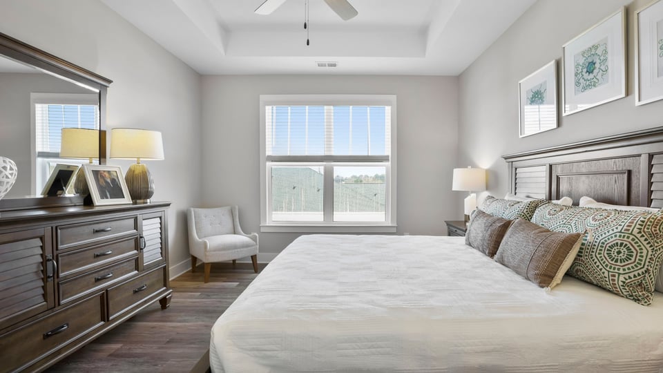Primary bedroom with closet and window.