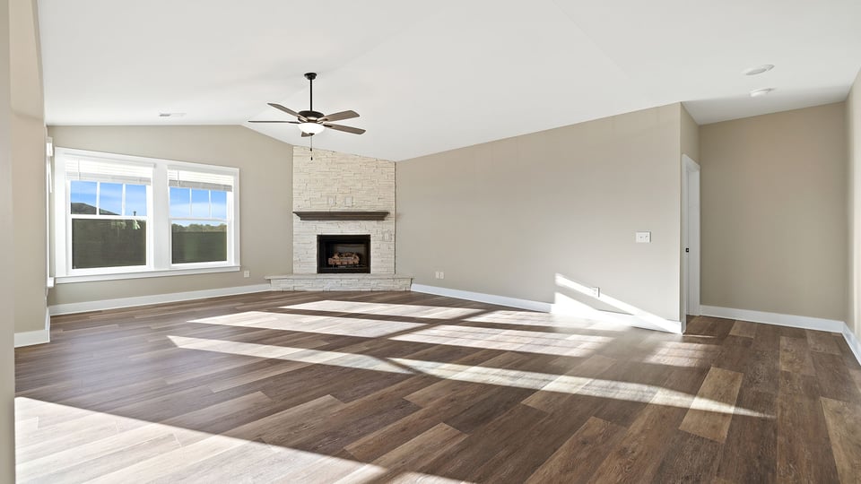Living room with fireplace and windows.