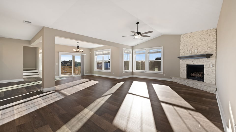 Living room with fireplace and windows.