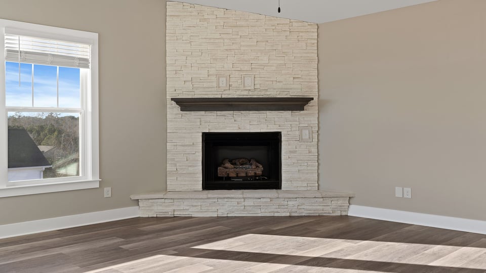 Living room with fireplace and windows.