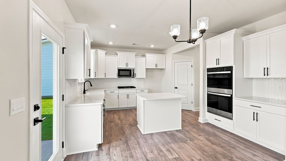 Kitchen with island and cabinets.