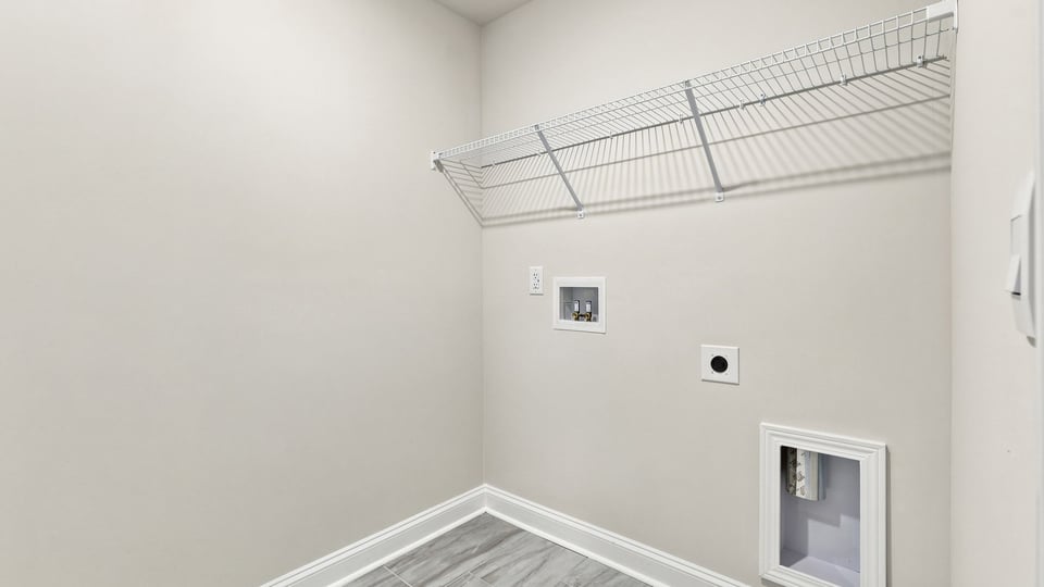 Laundry room with shelf.