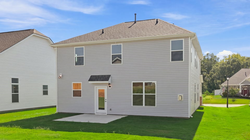 Back exterior with large backyard.