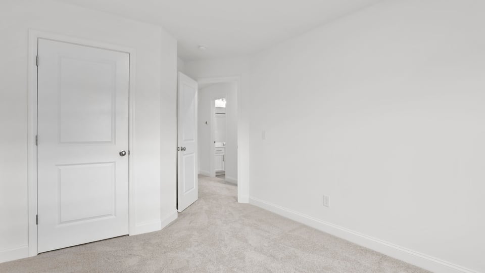 Bedroom with carpet and window.