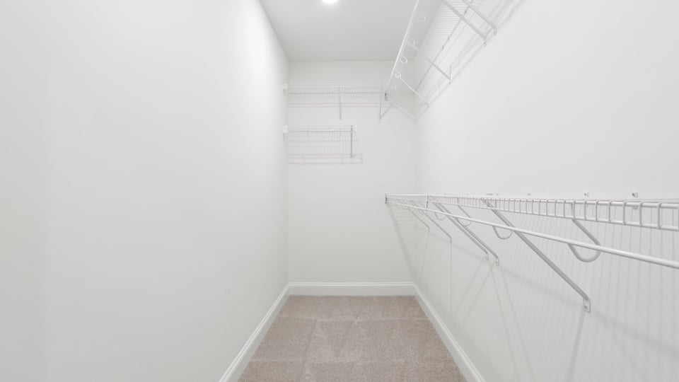 Primary closet with shelf.