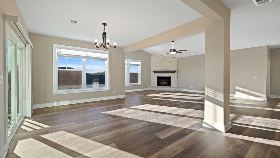 Living room with fireplace and windows.