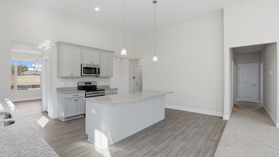 Kitchen and island feature quartz countertops.
