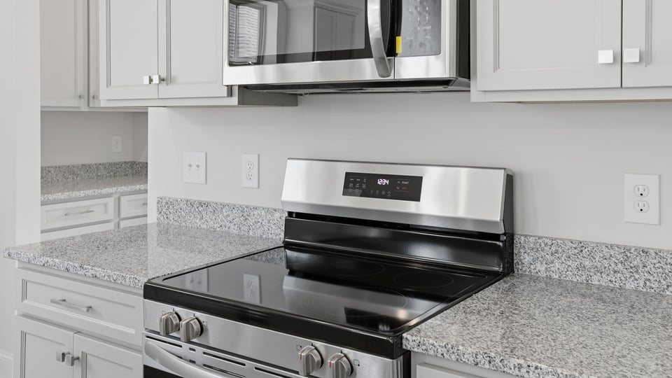 Stainless steel appliances enhance the kitchen.