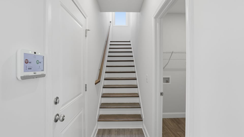 Stairwell to the upper level with a bedroom, bath and bonus room.