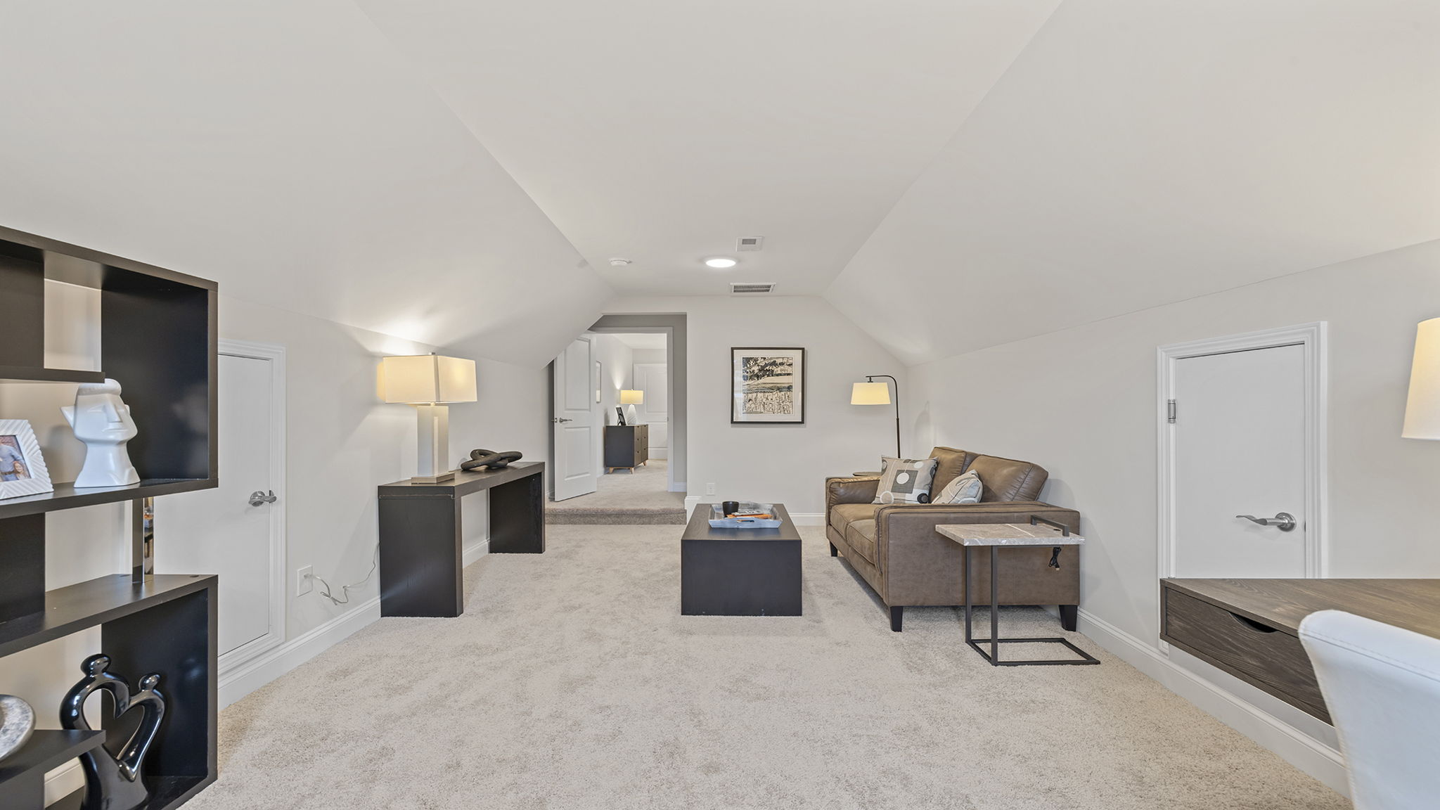 Loft area with windows and carpet.
