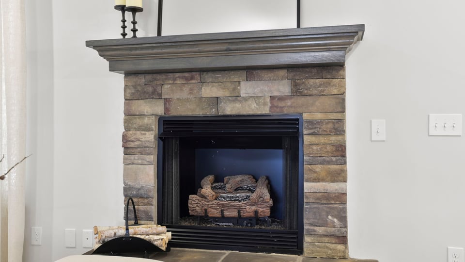 Living area with fireplace and windows.
