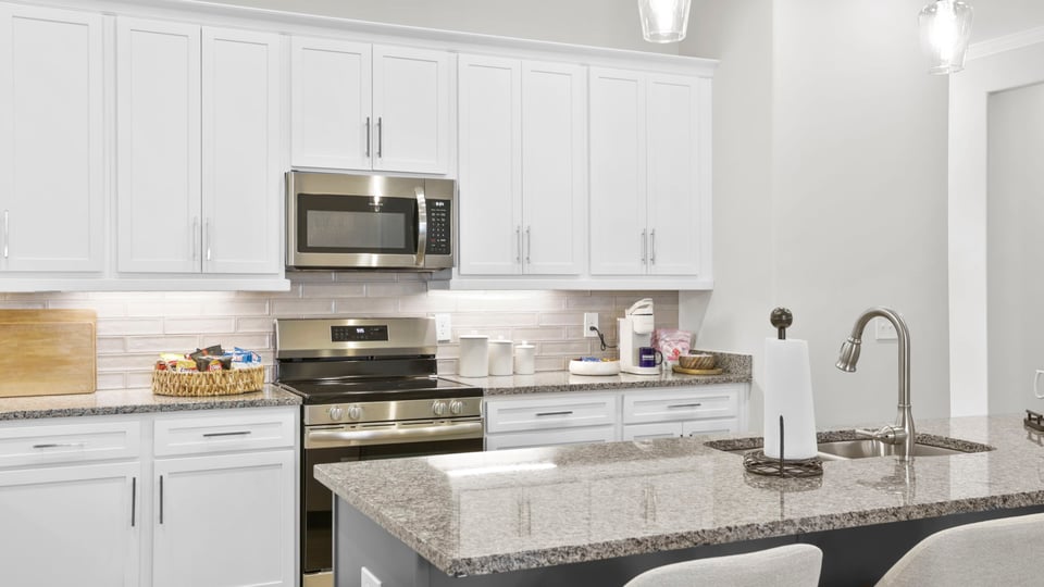 Kitchen with island and cabinets.