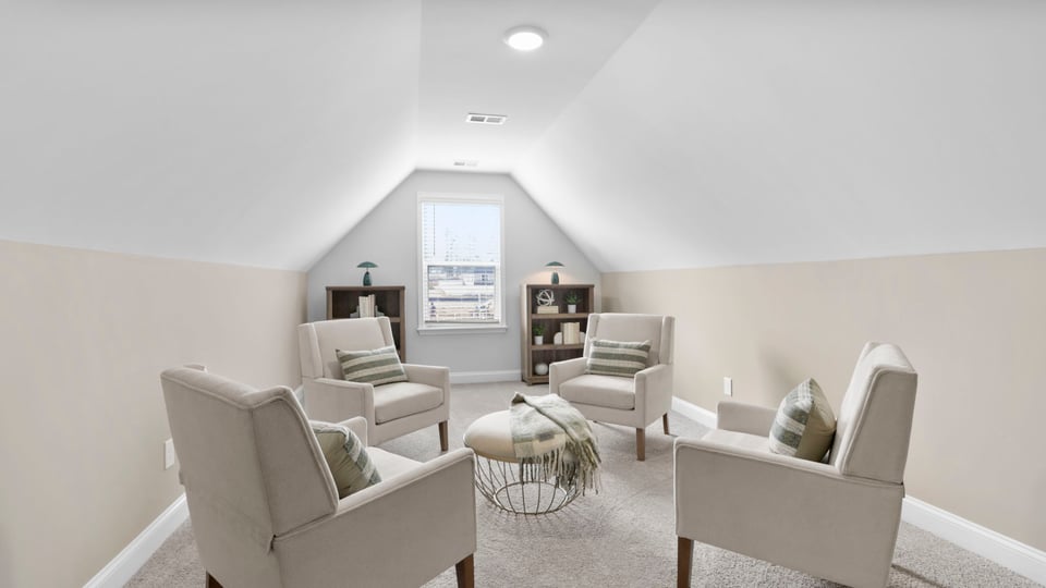 Loft area with carpet and window.