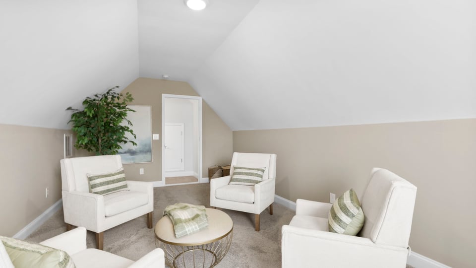 Loft area with carpet and window.