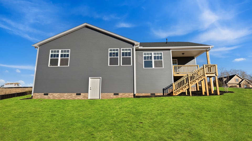 Back exterior with porch and large backyard.
