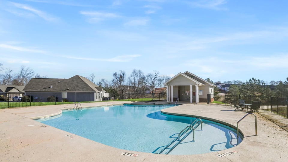 Pool area with clubhouse amenity.