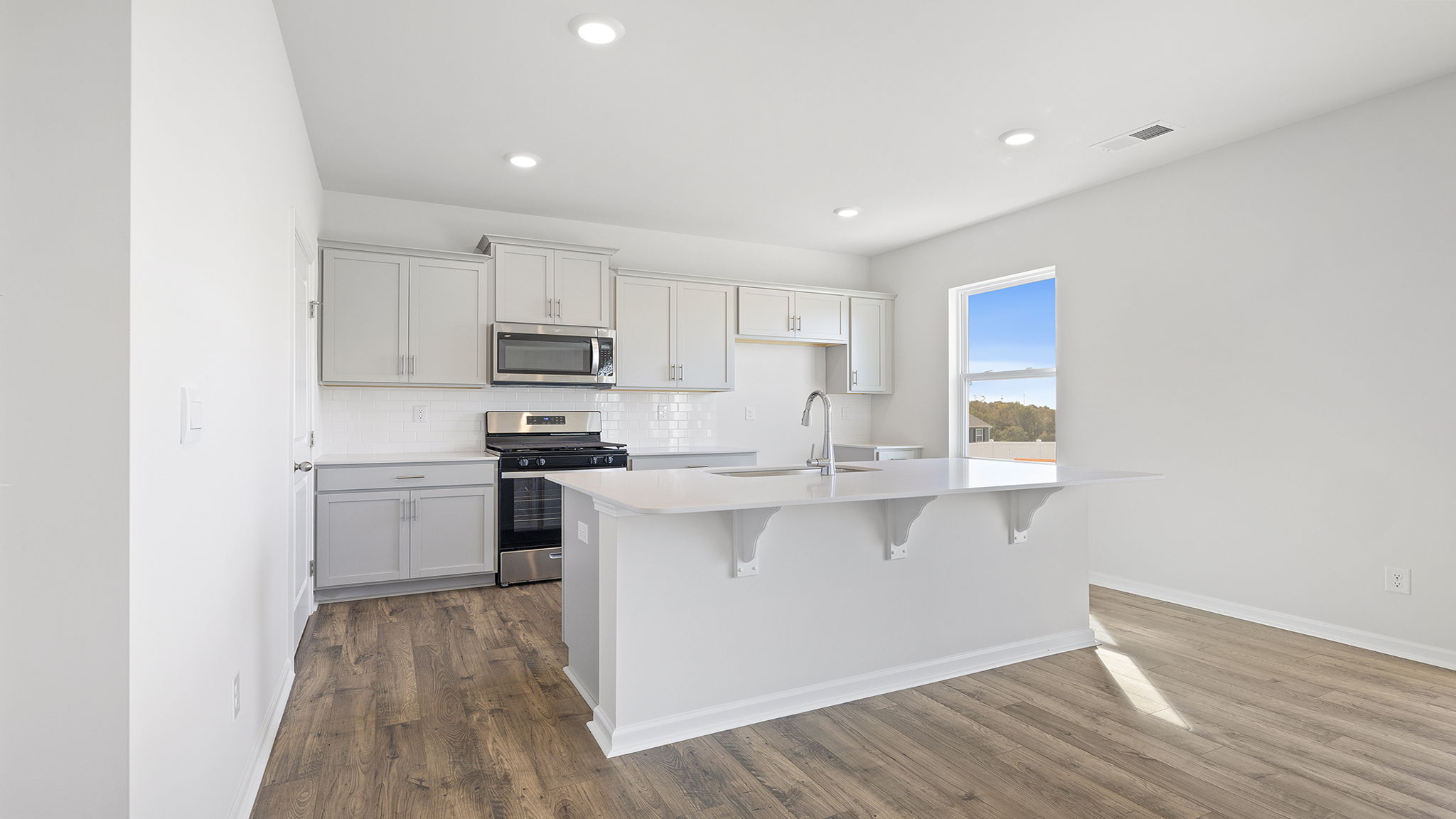 Kitchen and island with granite counter tops.