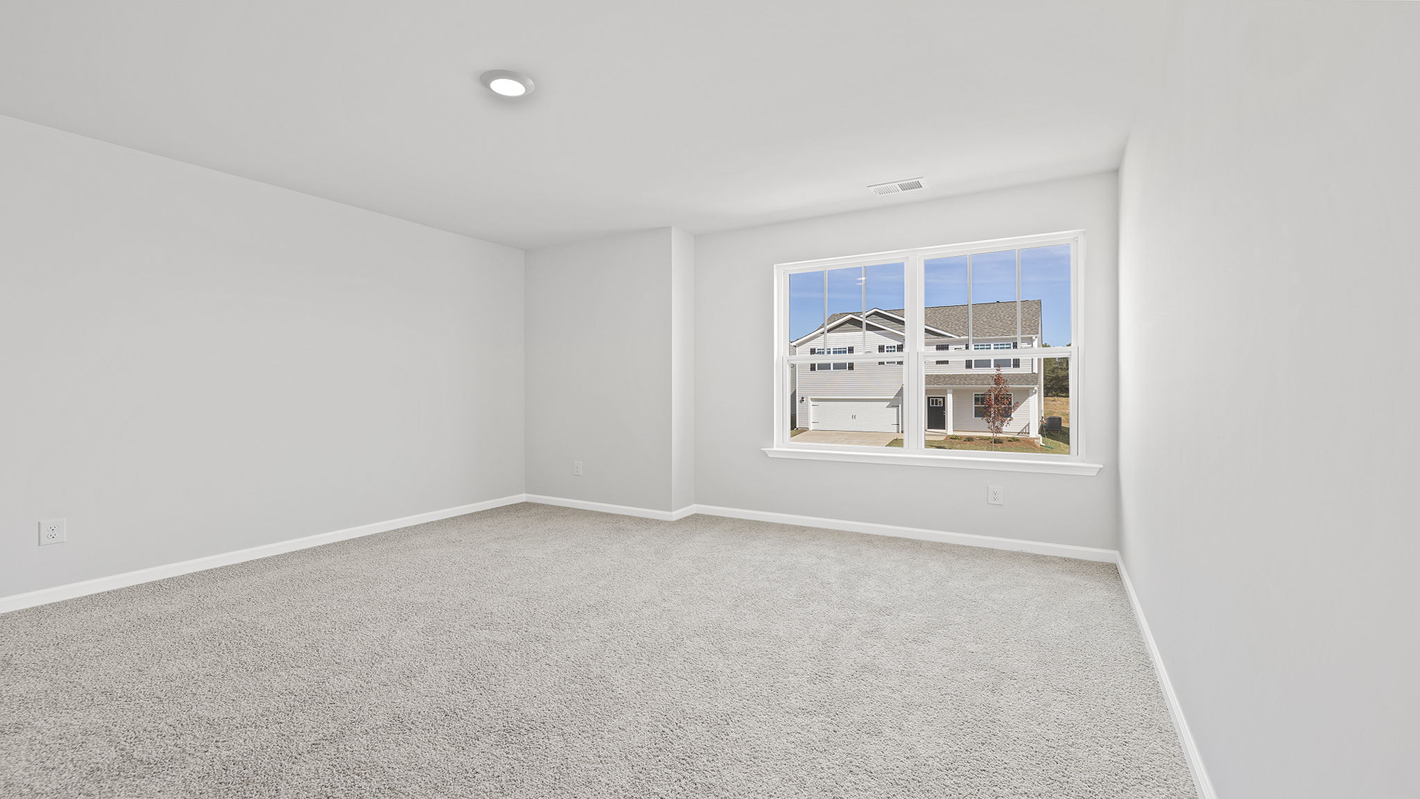 Bedroom with carpet and window.