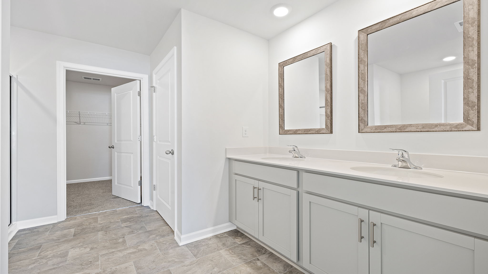 Bathroom with double vanity and walk in shower.