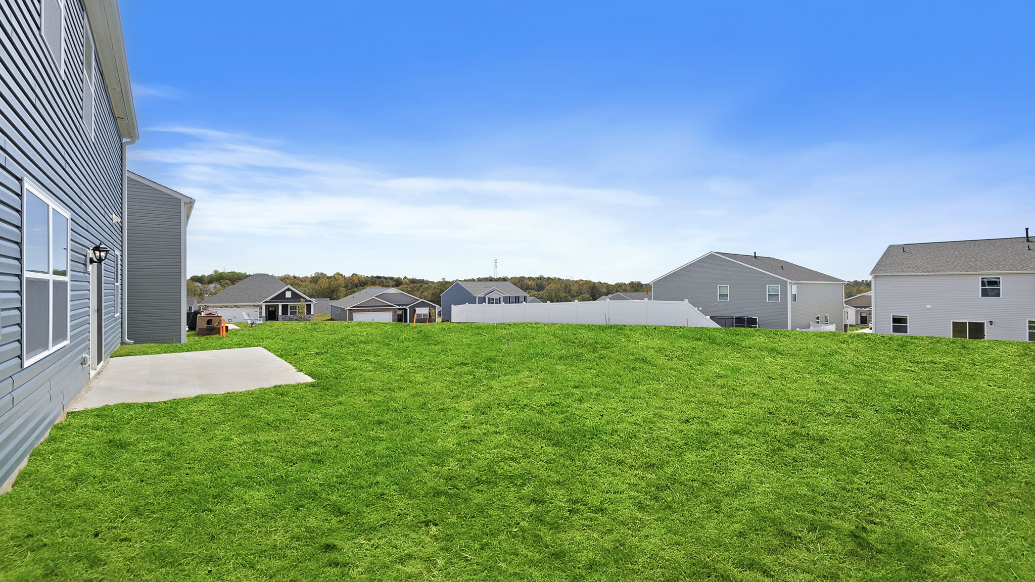 Exterior of home with large backyard.