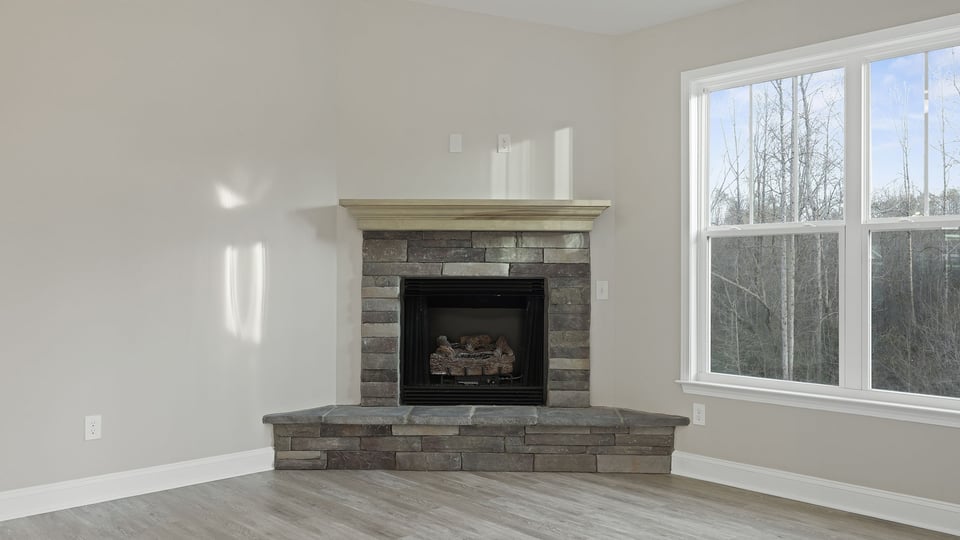 Family room with fireplace and window.