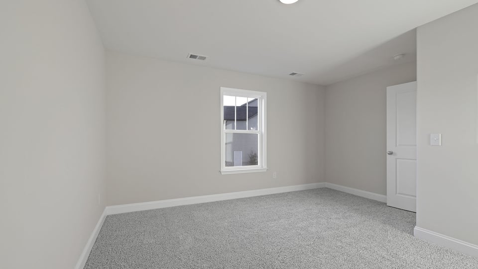 Bonus room with carpet and a window.