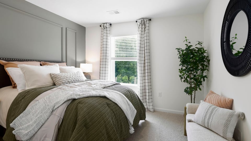 Bedroom with carpet and window.