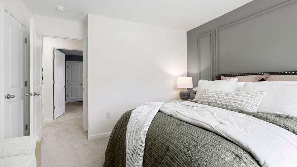 Bedroom with carpet and window.