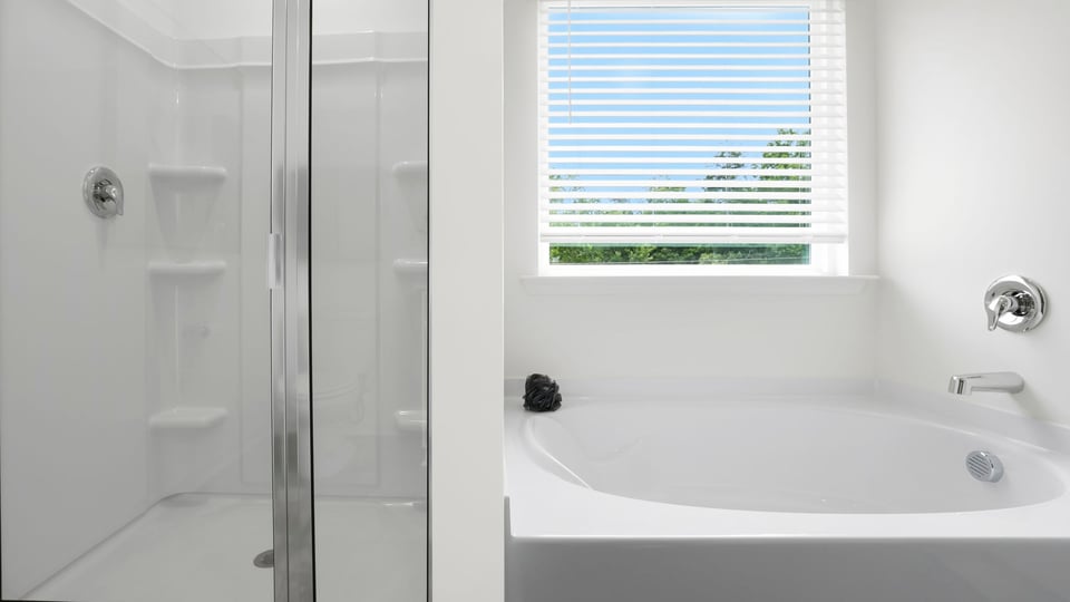 Bathroom with tub and window.