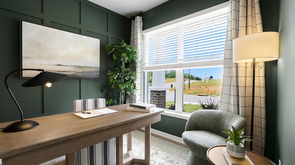 Flex room with office setup, and large window.