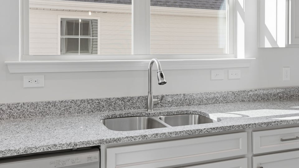Kitchen and island with granite counter tops.