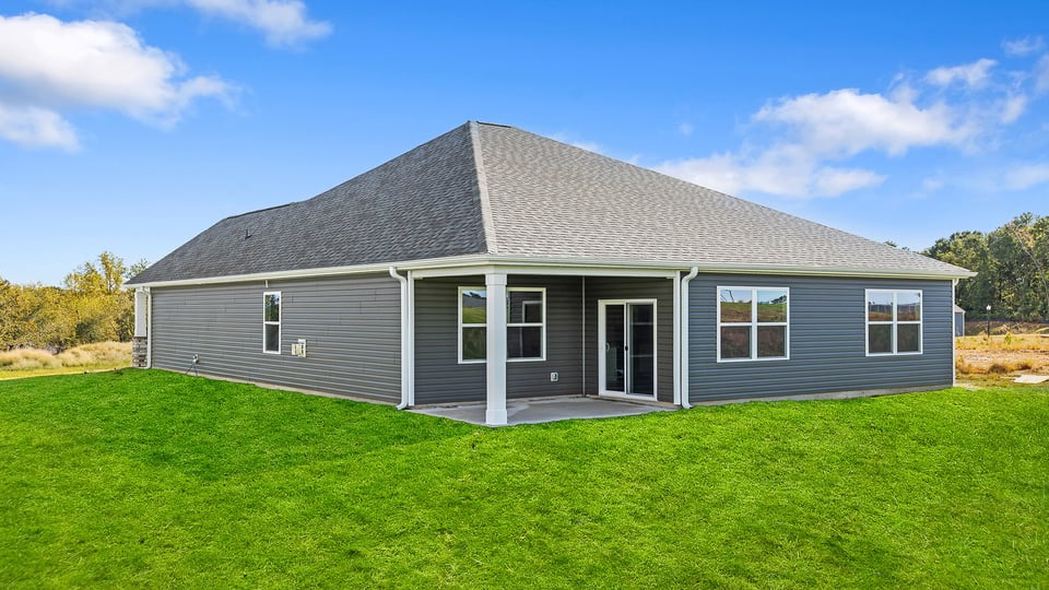 Exterior of home with large backyard.