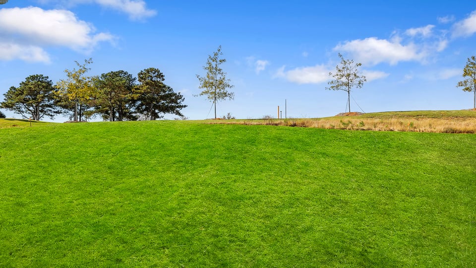 Exterior of home with large backyard.