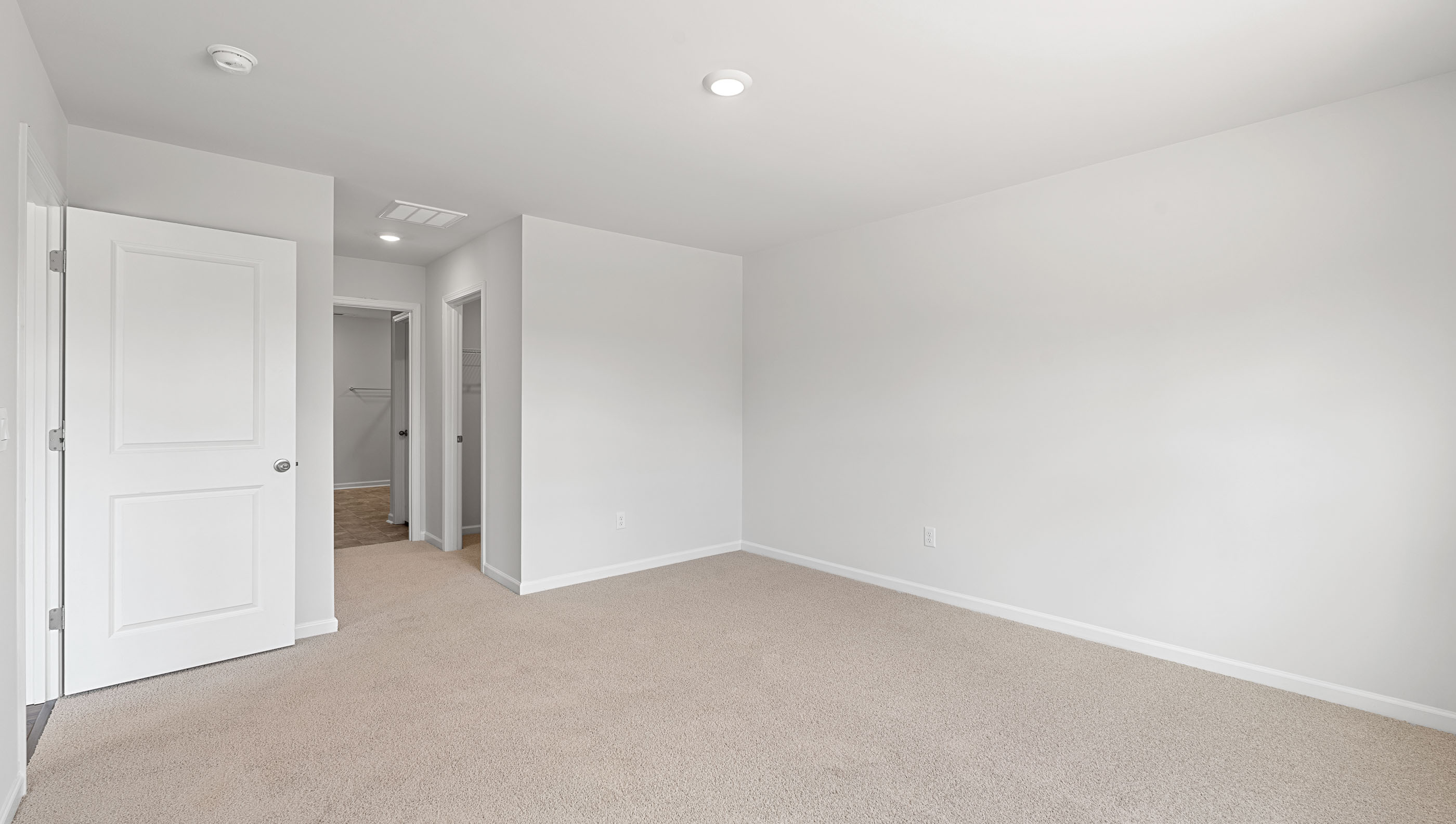 Bedroom with carpet and windows.
