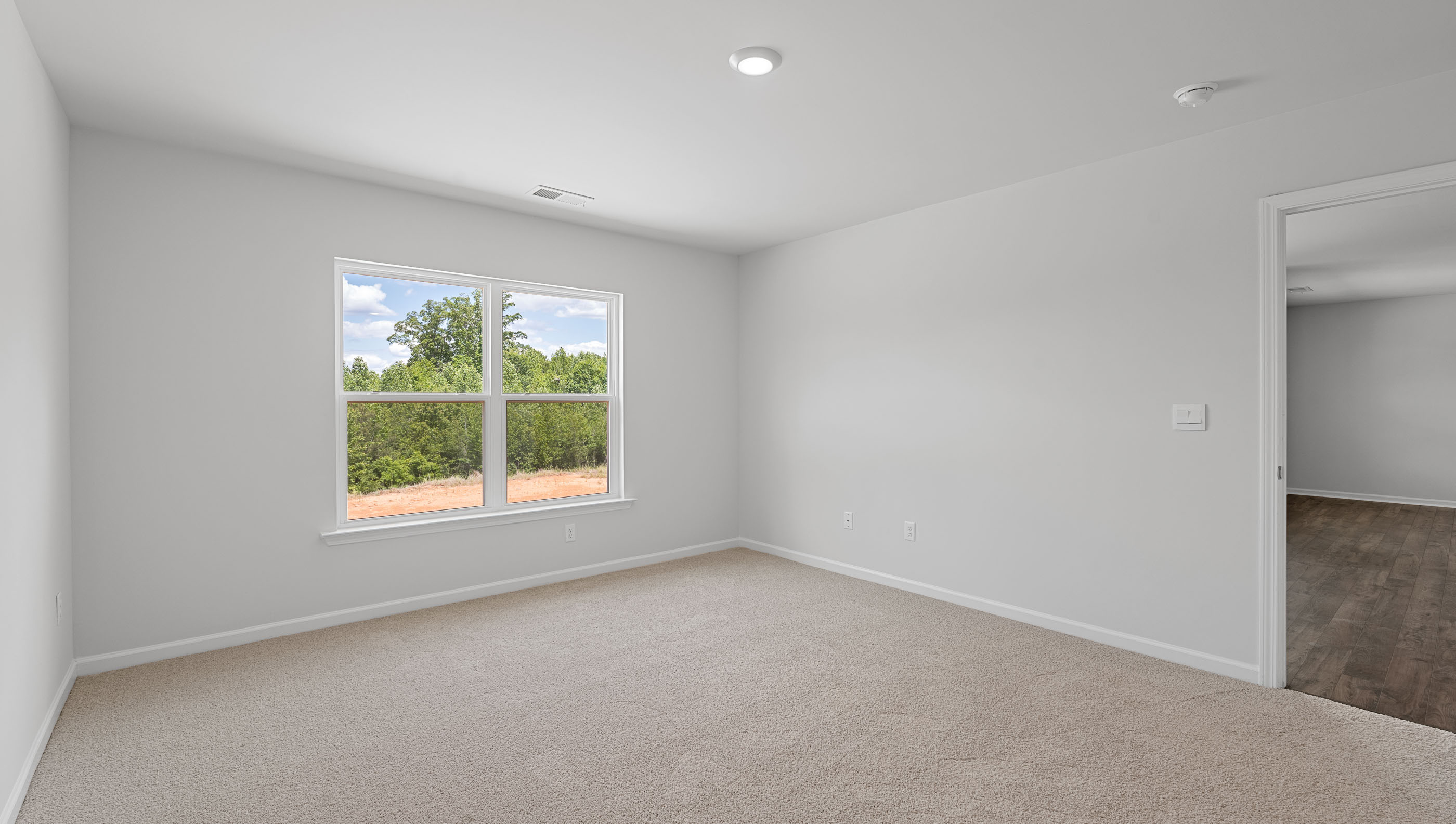 Bedroom with carpet and windows.