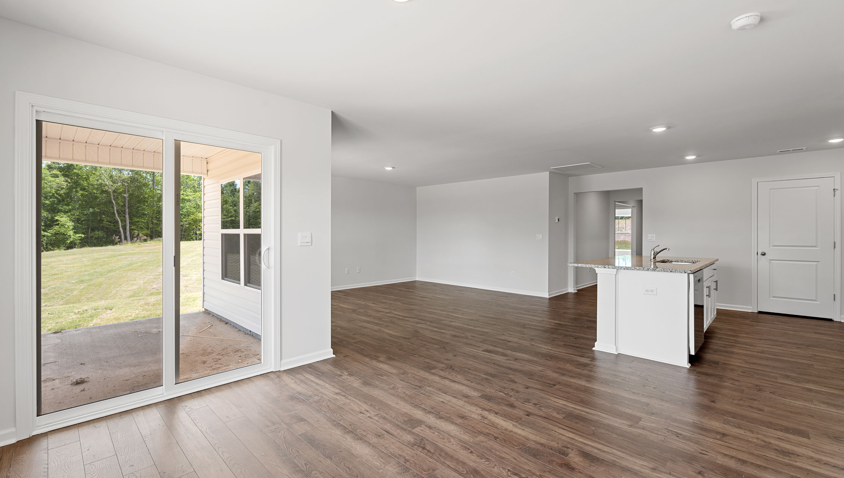 Living room with dining room and windows.