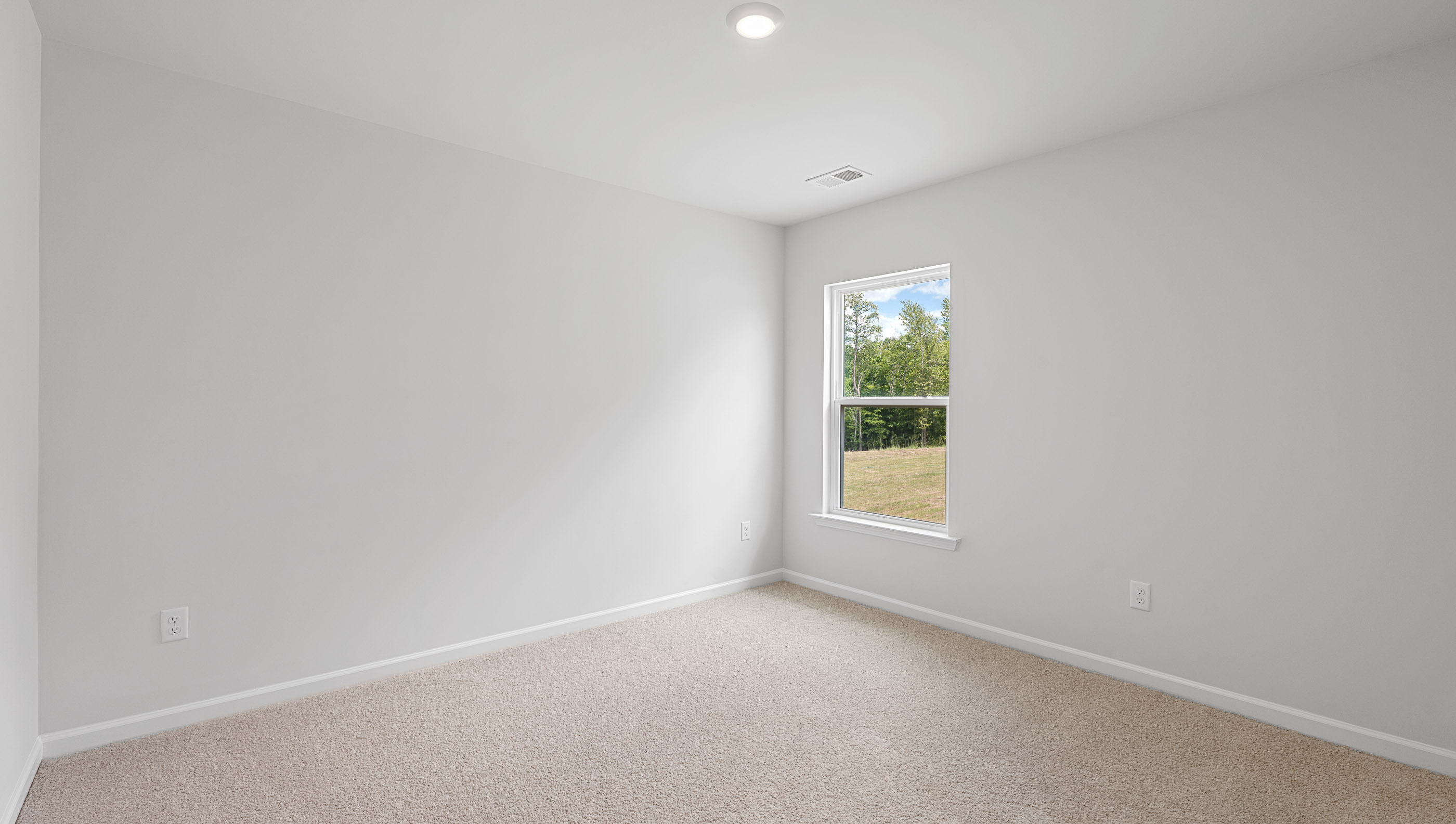 Bedroom with carpet and windows.