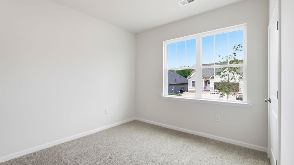 Bedroom with carpet and window