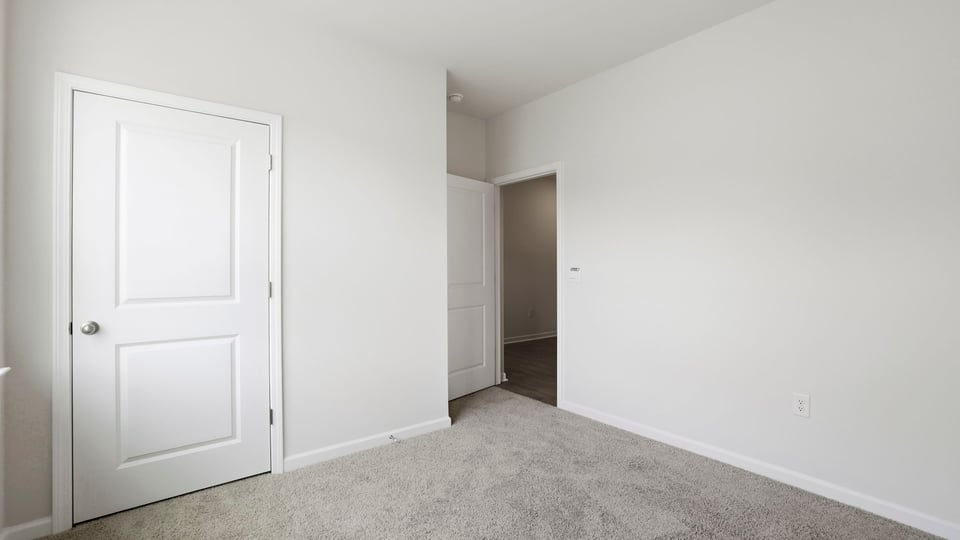 Bedroom with carpet and closet