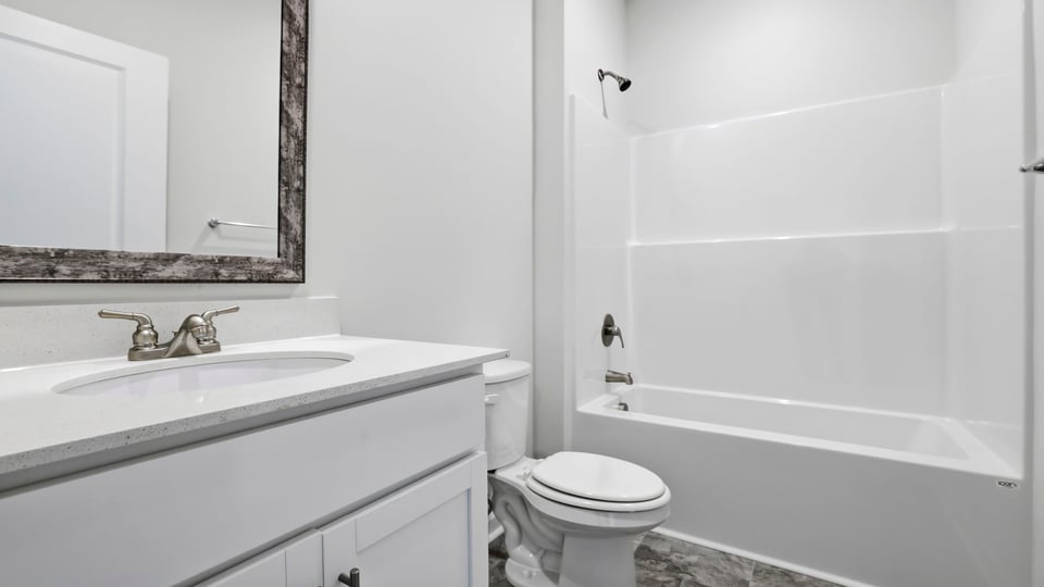 Bathroom with single vanity sink, shower, toilet