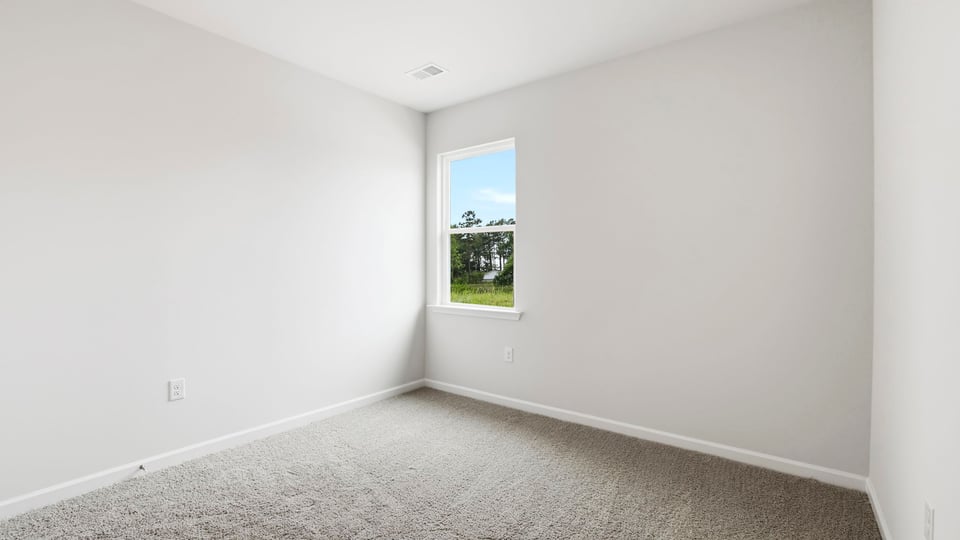 Bedroom with carpet and window