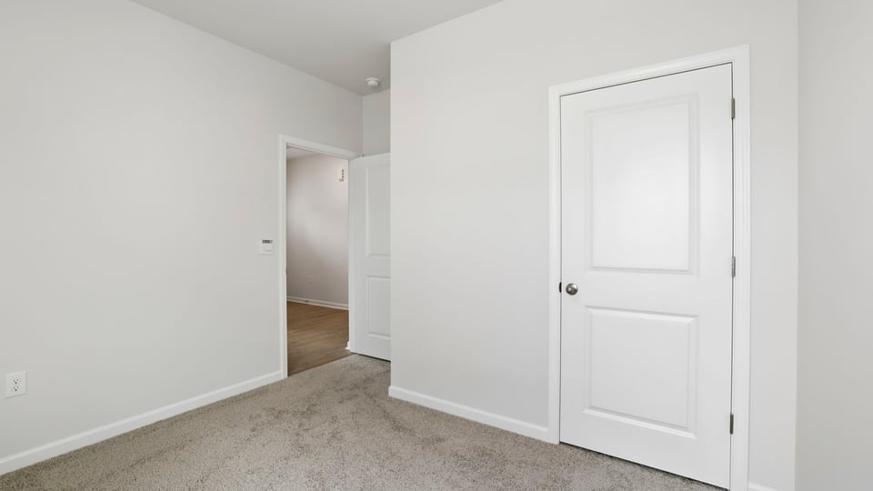 Bedroom with carpet and closet