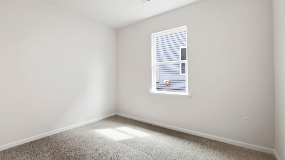 Bedroom with carpet and window