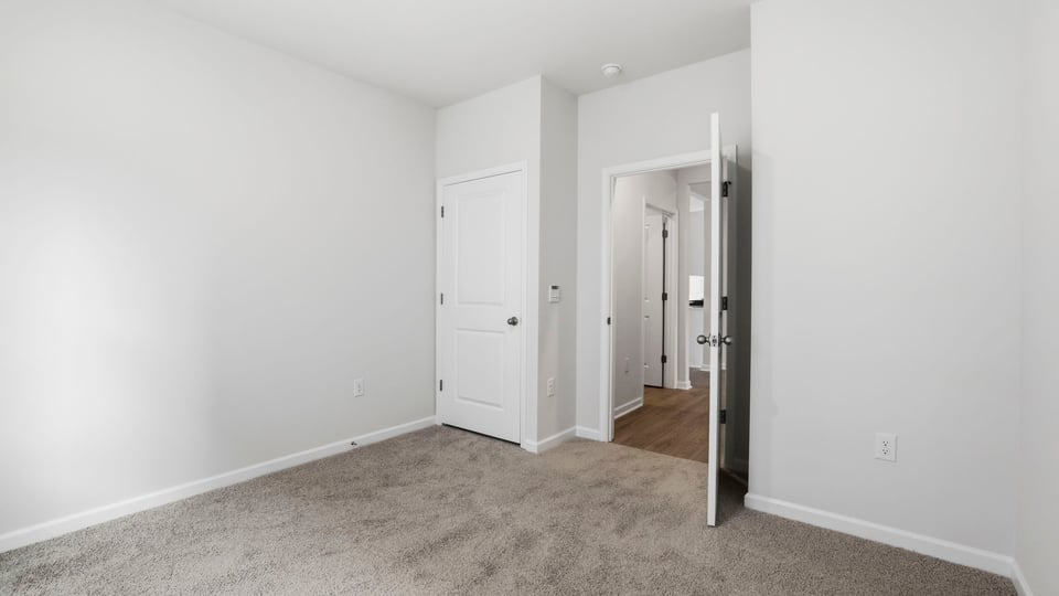Bedroom with carpet and closet