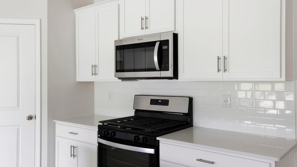 Close up counter top, stove, microwave