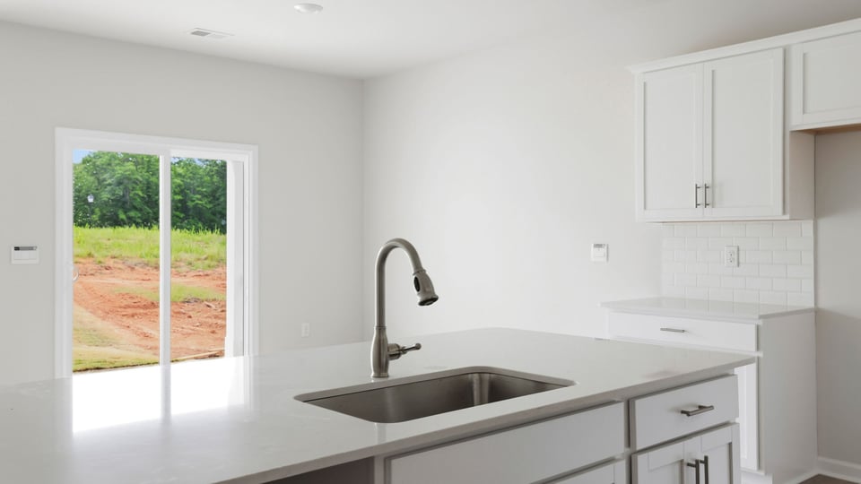 Close up sink and dinking area with sliding glass back door