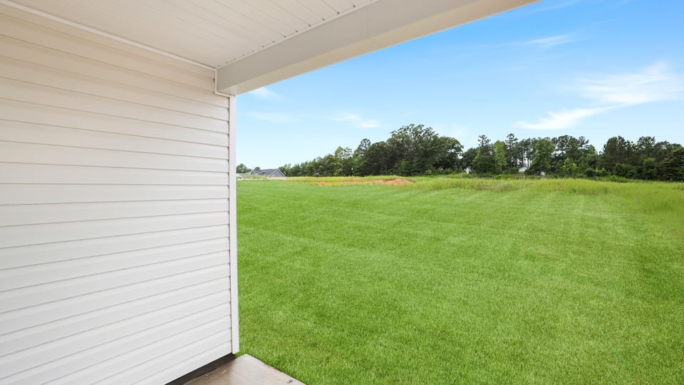 Back of the exterior with view of large backyard