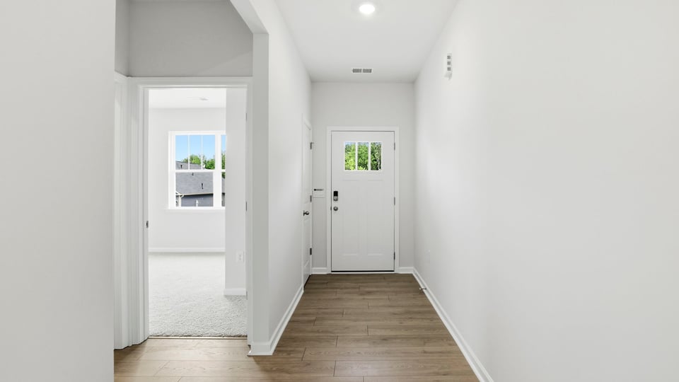 View of front door and office/sunroom from entryway