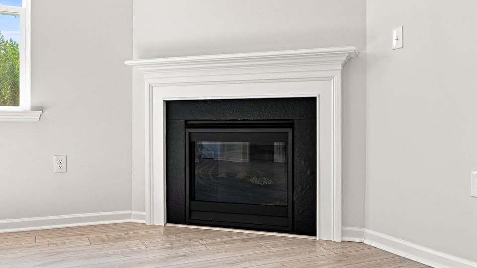 Living area with windows and fireplace.