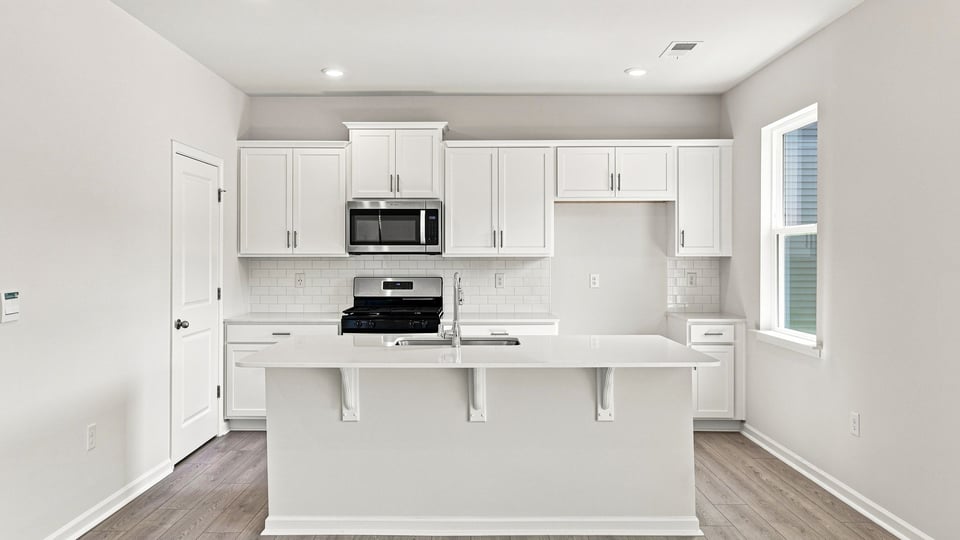 Kitchen with island and cabinets.